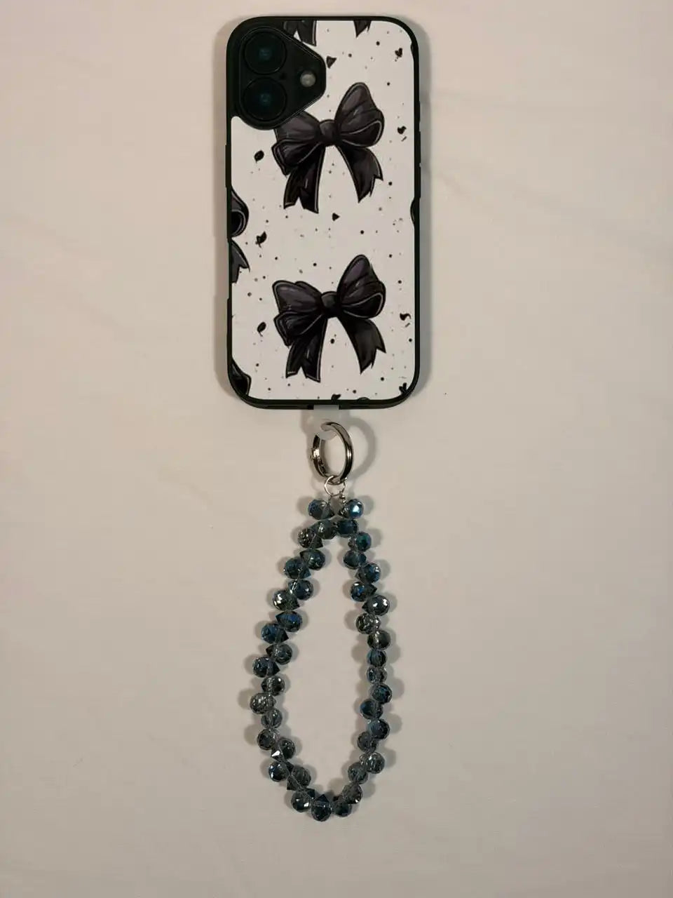 Blue crystal phone charm on a phone