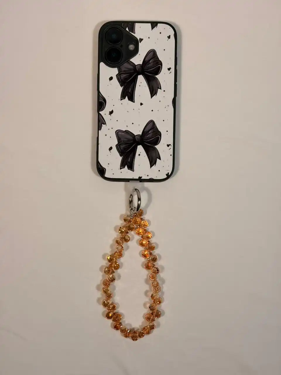 Gold crystal phone charm on a phone