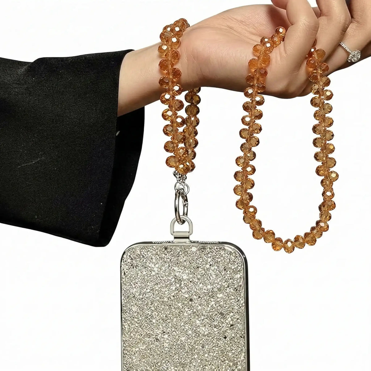 Gold crystal phone charm used as a wrist strap