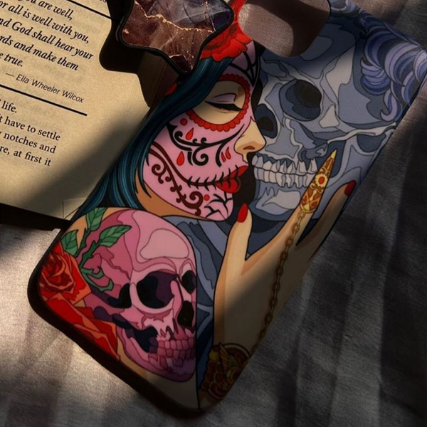 Skull print phone case by PhoneAntics and an open book
