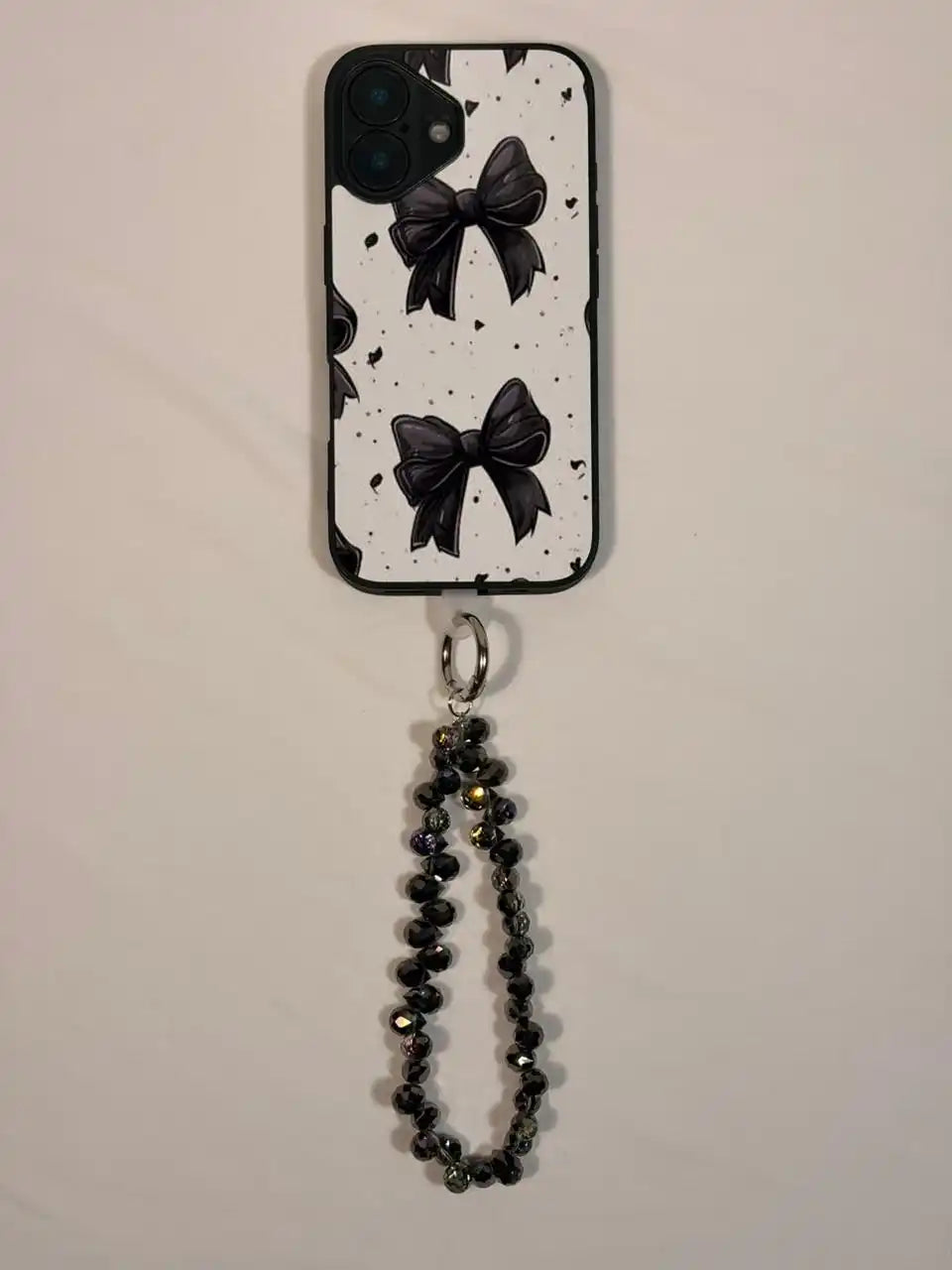 Black crystal phone charm on a phone