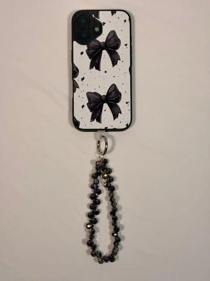 Black crystal phone charm on a phone