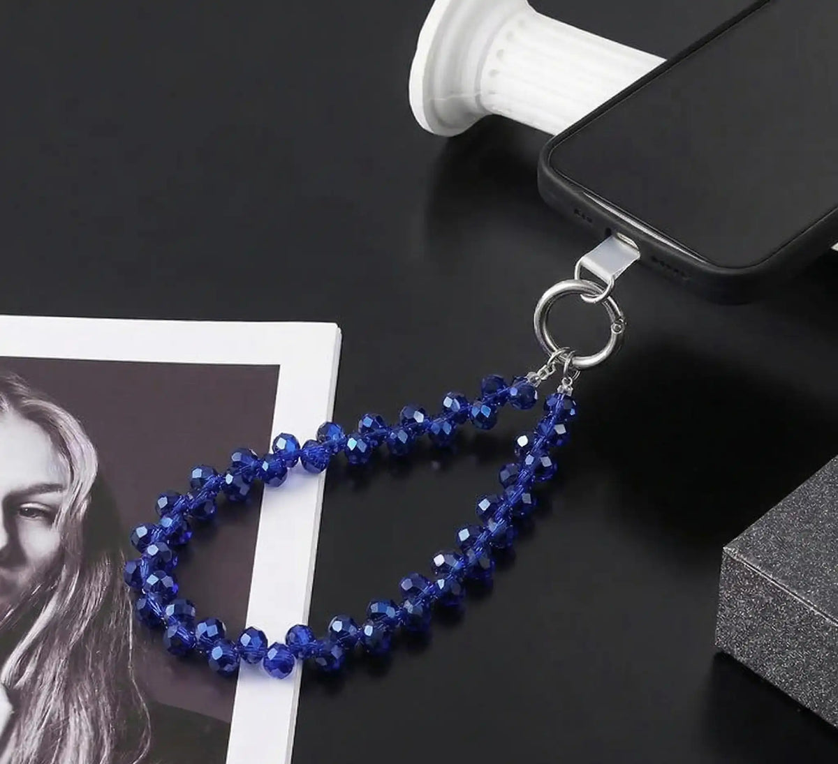 Blue crystal phone charm on a phone